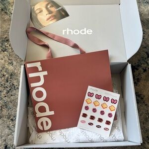 Large rhode by Hailey Bieber “toast” gift bag , sticker sheet, & shipping box